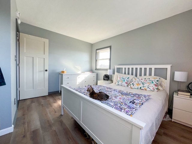 bedroom with baseboards and wood finished floors