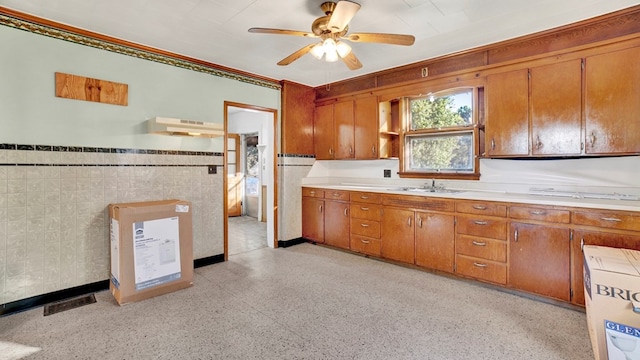 kitchen with ceiling fan, sink, and fridge