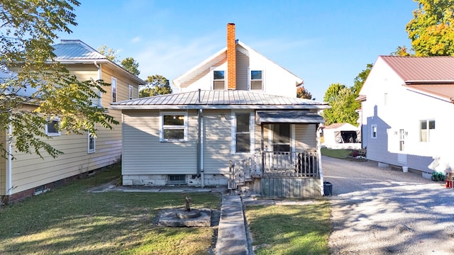 rear view of house with a yard