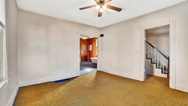 spare room with carpet flooring and ceiling fan