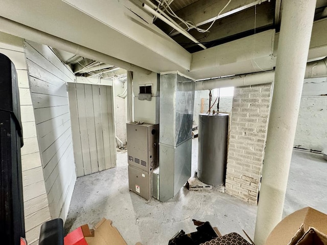 basement featuring heating unit, wooden walls, and gas water heater