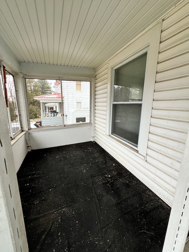 unfurnished sunroom with wood ceiling