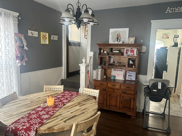 dining room featuring dark hardwood / wood-style flooring and a chandelier