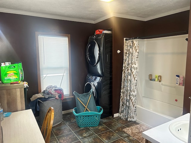 clothes washing area with crown molding, stacked washing maching and dryer, and a textured ceiling