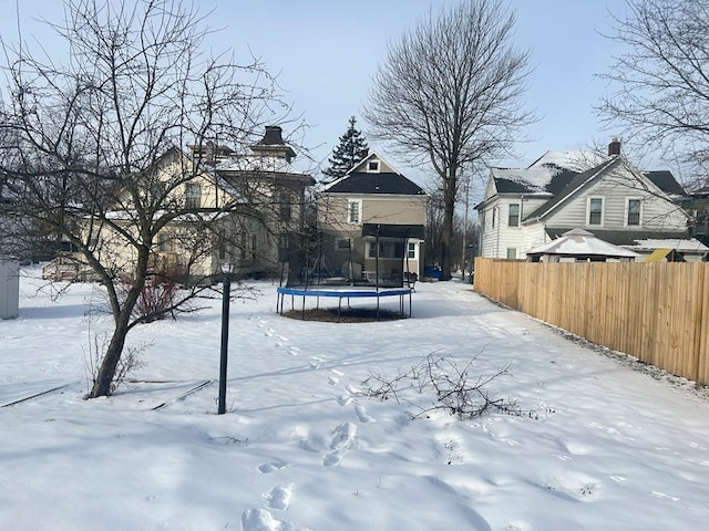 snowy yard with a trampoline