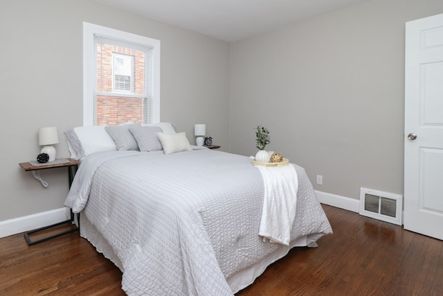 bedroom with dark hardwood / wood-style floors