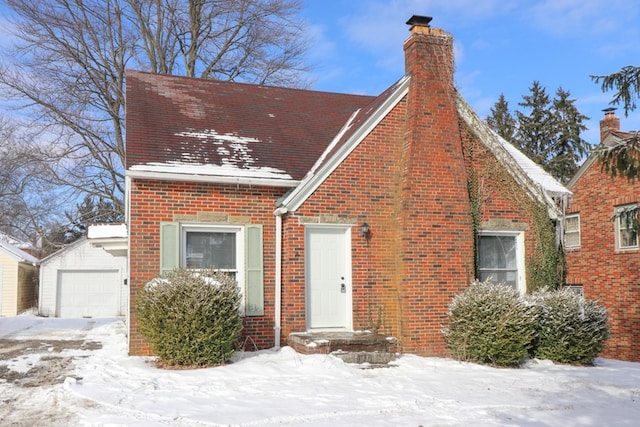 view of front of property featuring a garage and an outdoor structure