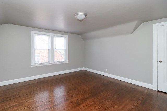 bonus room featuring lofted ceiling and dark wood-type flooring