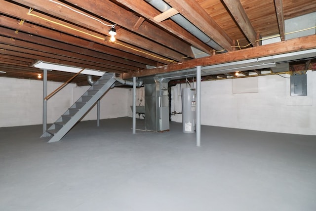 basement featuring heating unit, electric panel, and electric water heater