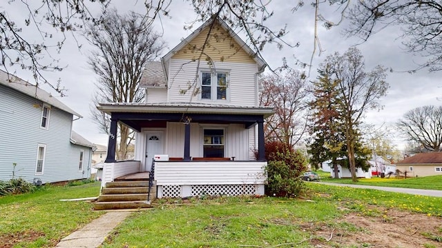 view of front of house with a front lawn, a porch, and board and batten siding