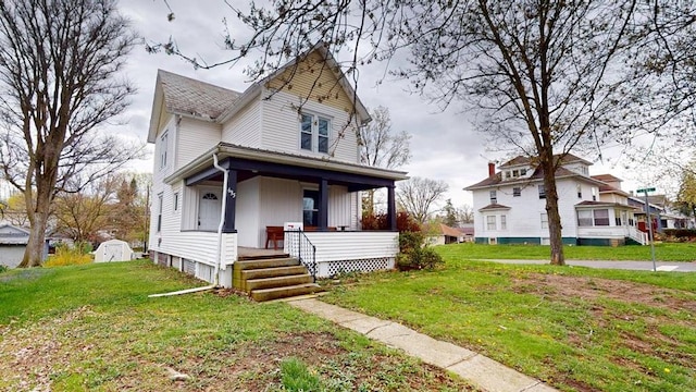 victorian house featuring a porch and a front yard