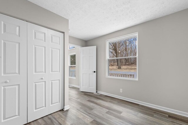 7326 State Route 19 Unit U3 L57-59, Mount Gilead, OH 43338 - unfurnished bedroom with a closet, wood finished floors, and a textured ceiling
