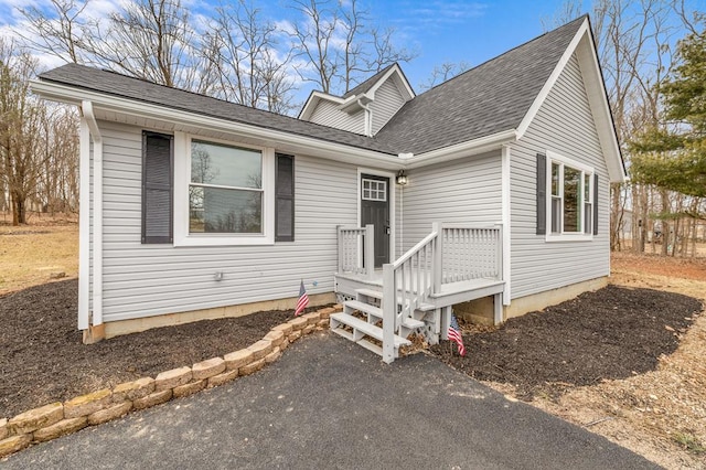 view of front of home featuring roof with shingles