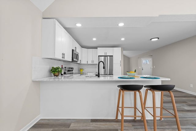 7326 State Route 19 Unit U3 L57-59, Mount Gilead, OH 43338 - kitchen with stainless steel appliances, a peninsula, dark wood-style flooring, white cabinets, and recessed lighting