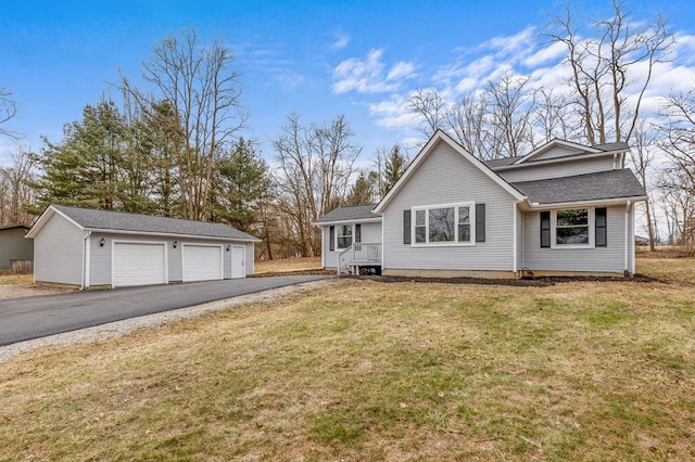 ranch-style home with an outbuilding, roof with shingles, a front yard, and a garage