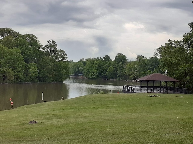 surrounding community with a gazebo, a lawn, a water view, and a view of trees