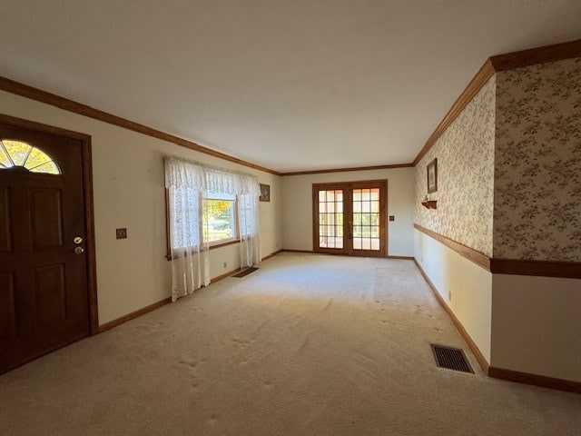 interior space with french doors and crown molding