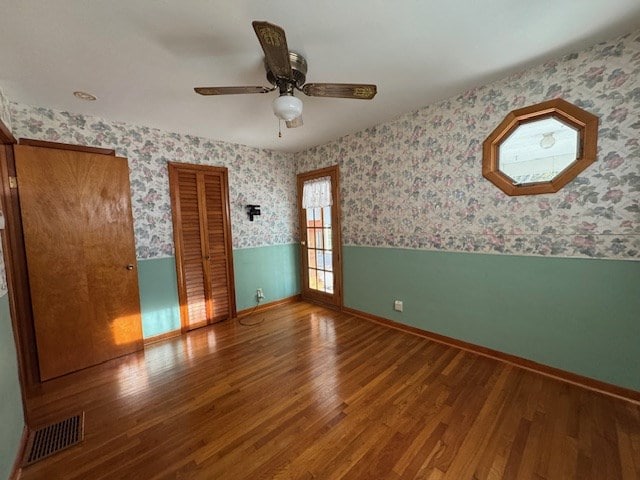 empty room with ceiling fan and wood-type flooring