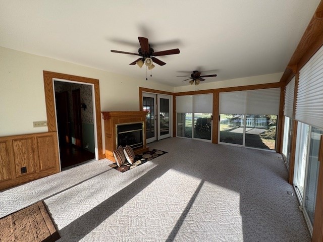 interior space with carpet floors and ceiling fan