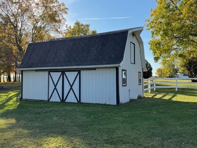 view of outdoor structure featuring a lawn