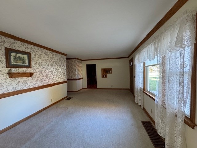 carpeted spare room with ornamental molding