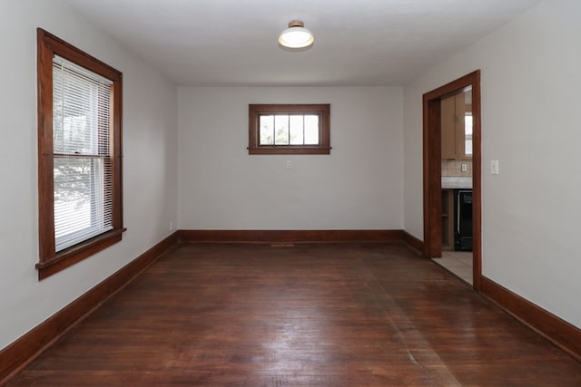 unfurnished room featuring wood finished floors and baseboards
