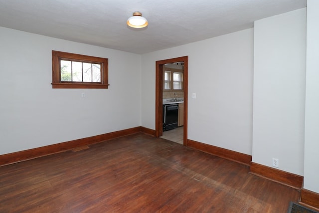 unfurnished room featuring visible vents, light wood-type flooring, baseboards, and a sink