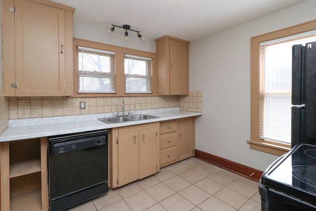 kitchen featuring baseboards, a sink, black appliances, light countertops, and tasteful backsplash