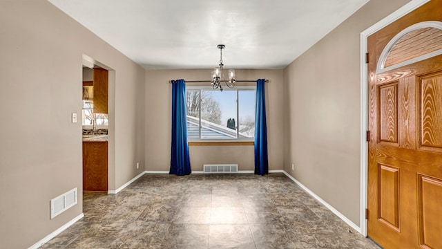 unfurnished dining area featuring an inviting chandelier