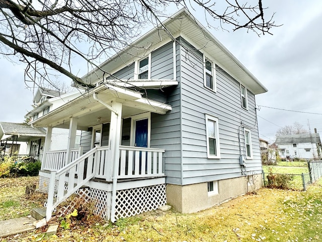 view of side of property featuring a porch