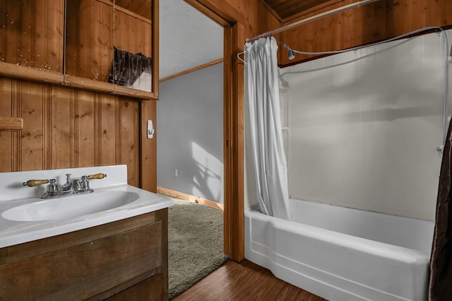 bathroom with hardwood / wood-style floors, shower / bath combination with curtain, and vanity