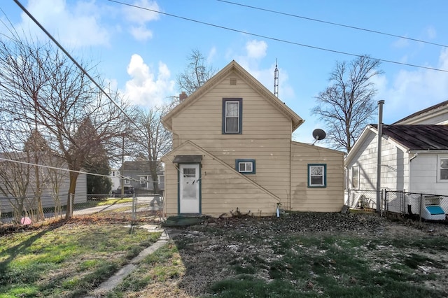 rear view of house featuring a yard