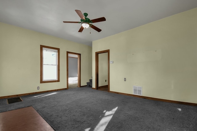 carpeted spare room featuring ceiling fan