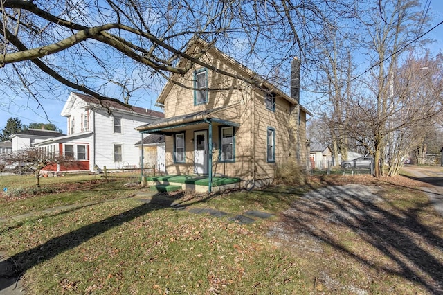 view of front facade with a front yard and a porch