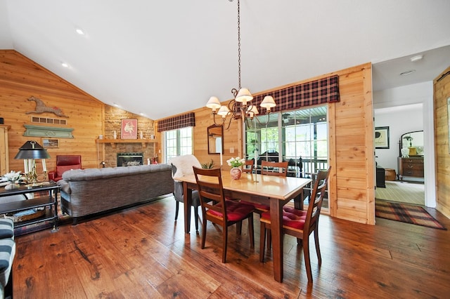 7326 State Route 19 Unit 1-2, Mount Gilead, OH 43338 - dining room with wooden walls, a chandelier, vaulted ceiling, hardwood / wood-style floors, and a fireplace