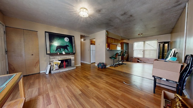 452 Daisy St, Mansfield, OH 44903 - living area with light wood-type flooring, a stone fireplace, and baseboards