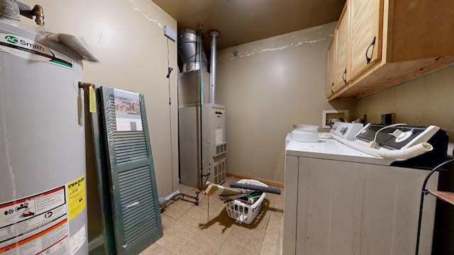452 Daisy St, Mansfield, OH 44903 - laundry area with washing machine and clothes dryer, gas water heater, cabinet space, and light tile patterned floors