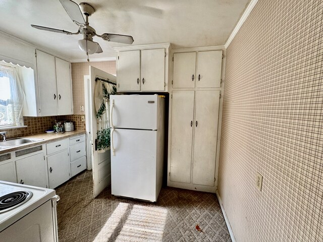 625 Grove Ave, Galion, OH 44833 - kitchen featuring white appliances, crown molding, a ceiling fan, light countertops, and decorative backsplash