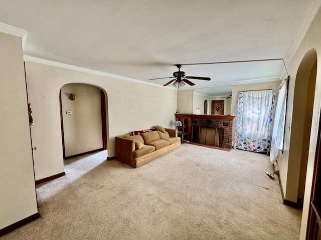 625 Grove Ave, Galion, OH 44833 - carpeted living room with arched walkways, ornamental molding, a ceiling fan, and a brick fireplace