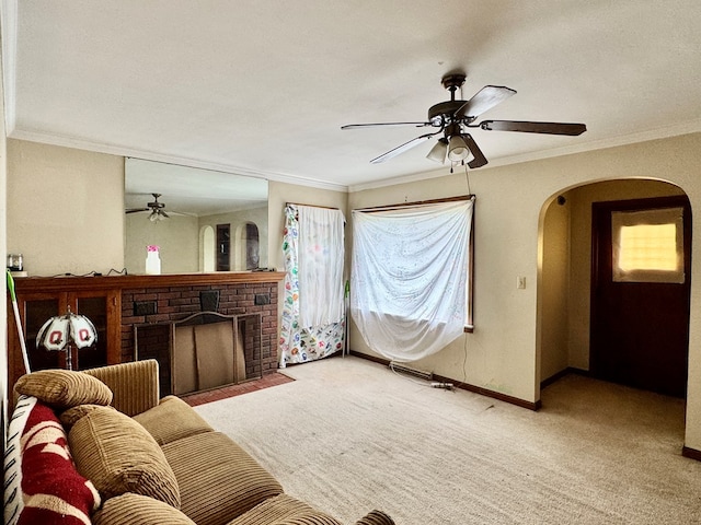 625 Grove Ave, Galion, OH 44833 - living area featuring ceiling fan, arched walkways, carpet flooring, a fireplace, and crown molding