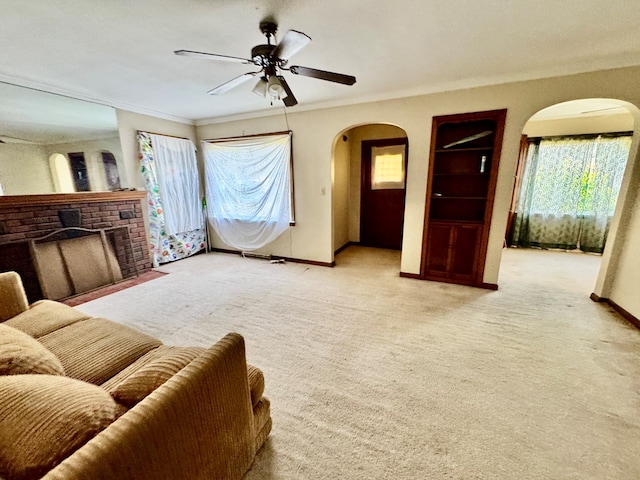 625 Grove Ave, Galion, OH 44833 - living area with arched walkways, crown molding, light colored carpet, and a ceiling fan