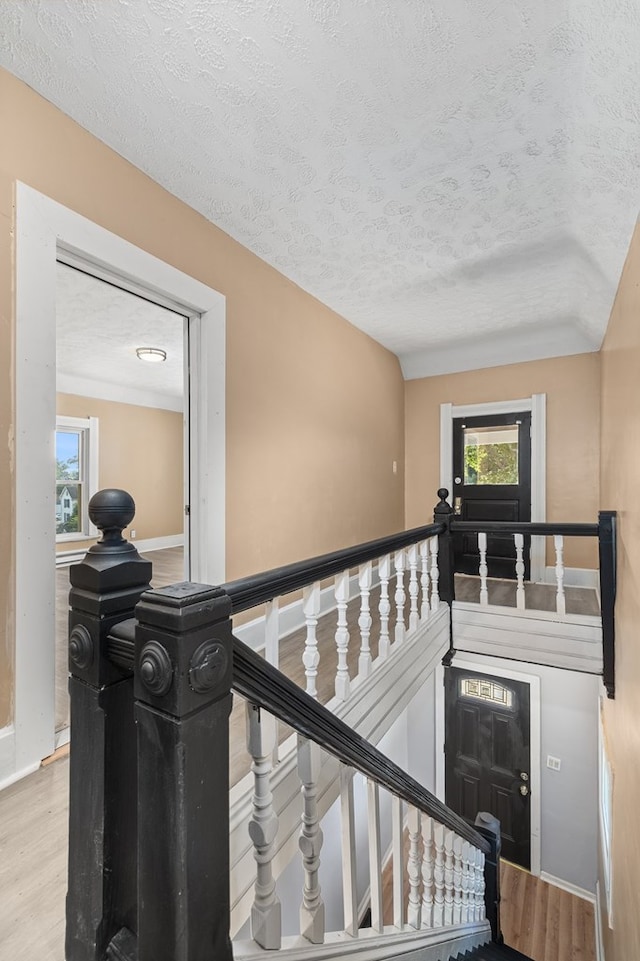 131 Sturges Ave, Mansfield, OH 44903 - stairs featuring a textured ceiling, healthy amount of natural light, and wood finished floors