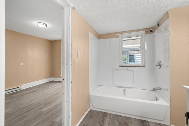 131 Sturges Ave, Mansfield, OH 44903 - bathroom featuring wood finished floors, a baseboard radiator, shower / tub combination, and a textured ceiling