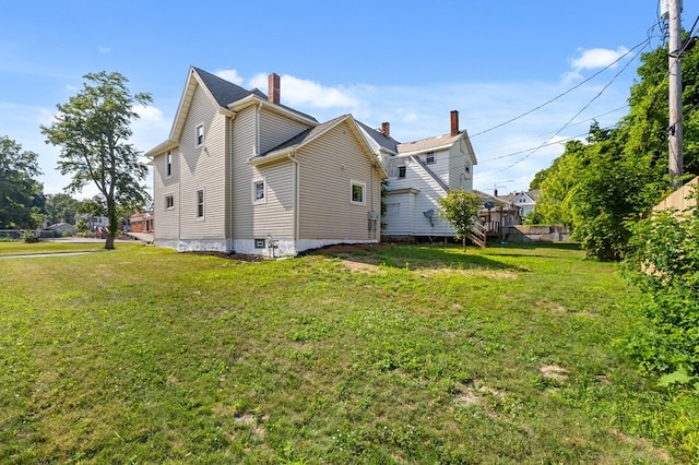 131 Sturges Ave, Mansfield, OH 44903 - rear view of house featuring a lawn and a chimney
