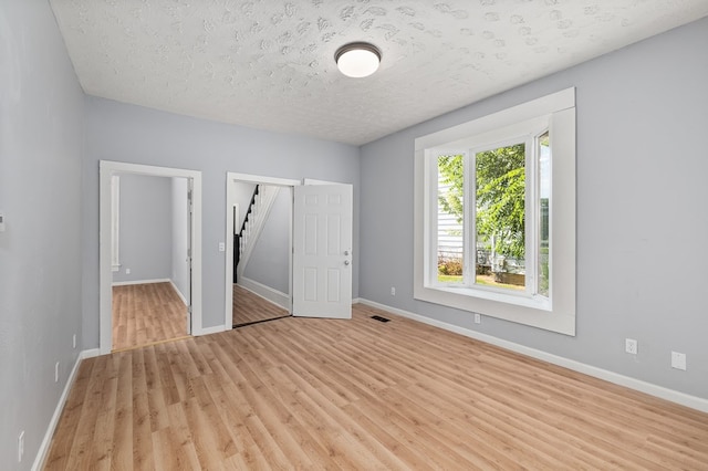 131 Sturges Ave, Mansfield, OH 44903 - unfurnished bedroom with light wood-style floors, a textured ceiling, and a closet