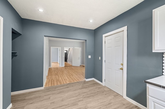 131 Sturges Ave, Mansfield, OH 44903 - hall with light wood-style floors, a textured ceiling, and recessed lighting