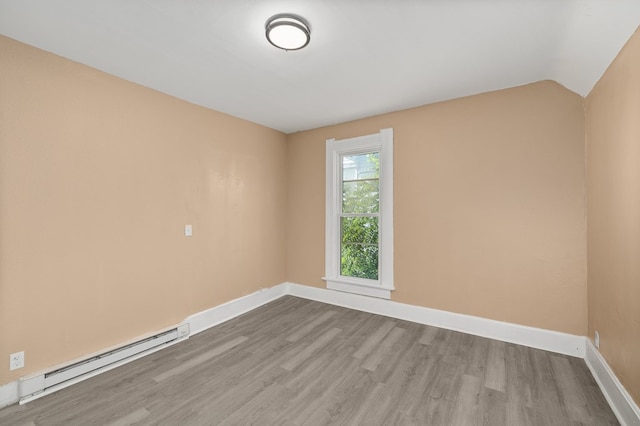 131 Sturges Ave, Mansfield, OH 44903 - empty room featuring baseboard heating, wood finished floors, and lofted ceiling