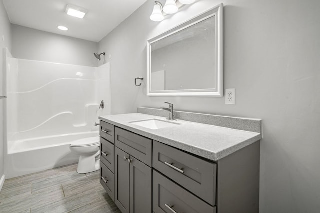 bathroom featuring vanity, shower / tub combination, toilet, and wood finished floors