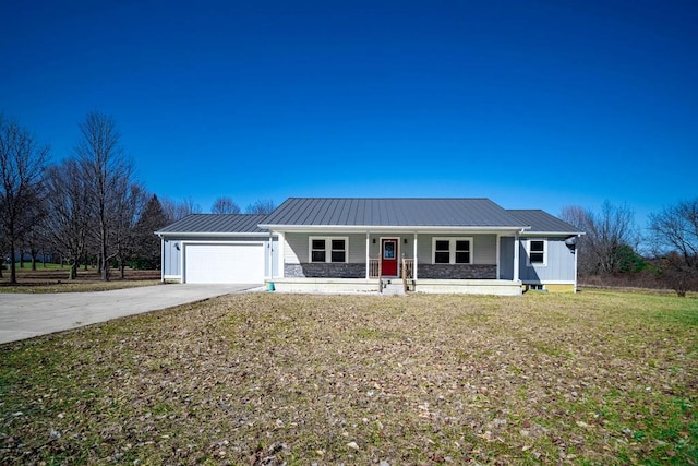 single story home with a front lawn, a porch, concrete driveway, metal roof, and a garage