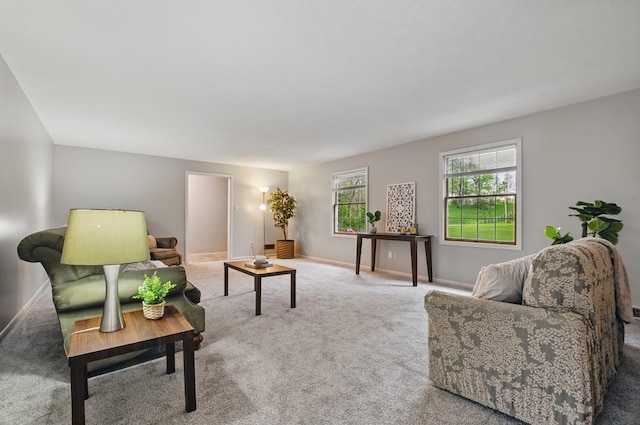 carpeted living room with baseboards